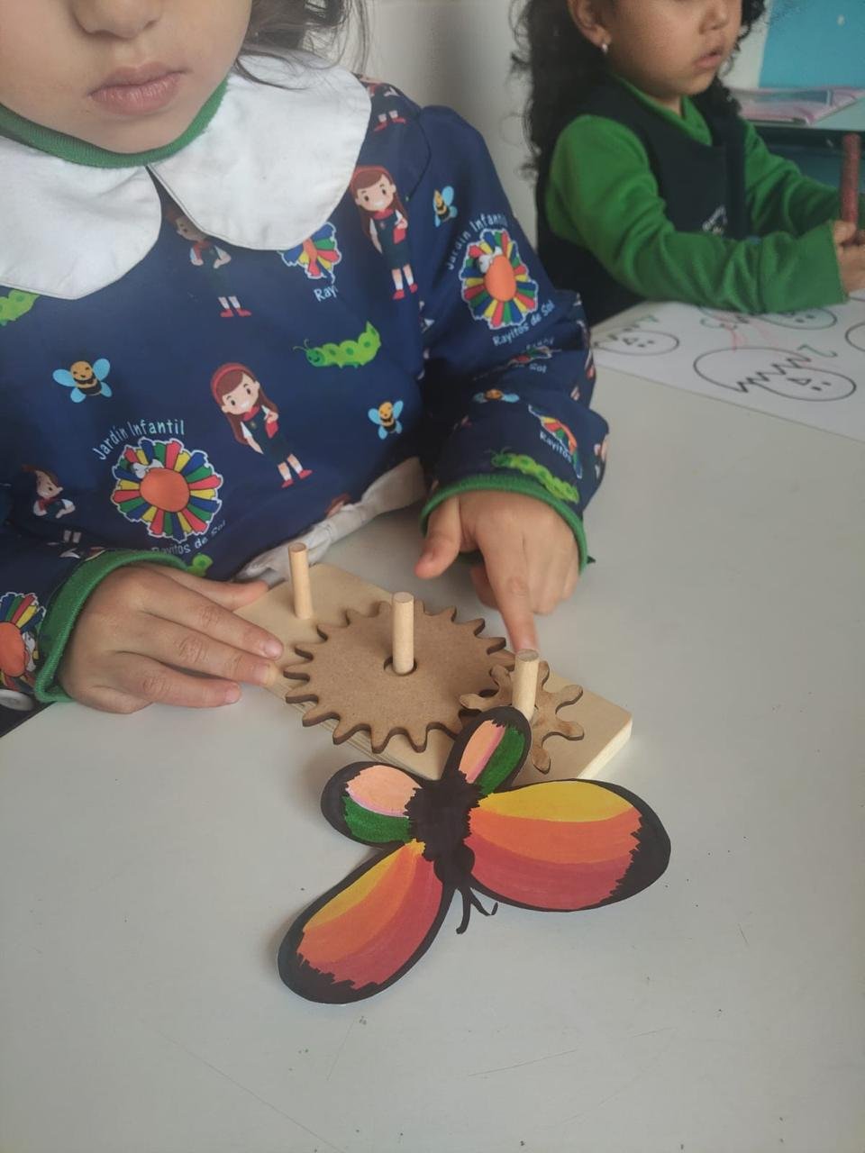 Niña explorando un mecanismo de engranajes en el Proyecto de Robótica
